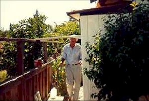 Don Dickinson's loft is situated on the side of a hill (his home is also, for that matter.  Pictured here is Don in front of his loft.  The loft sits up against the house and his landing pad is the "whole roof" The birds can't miss it.  